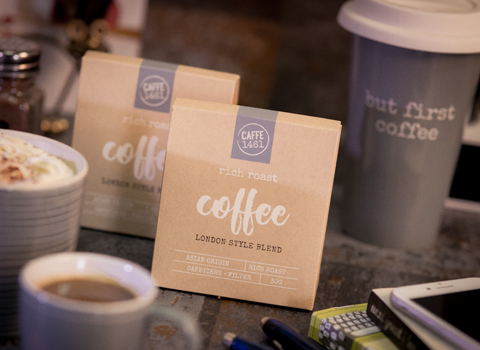 Coffee blend packets with travel mug in background